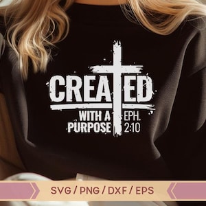 May include: A black sweatshirt with a white graphic design that says "CREATED WITH A PURPOSE EPH. 2:10". The graphic includes a white cross with a distressed look.