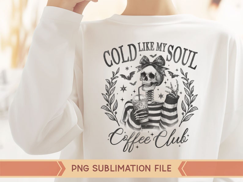 May include: A white t-shirt with a black and white graphic design featuring a skeleton holding a cup of coffee. The graphic says "Cold Like My Soul Coffee Club".