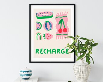 May include: A framed print with a pink background and green, blue, and red illustrations of fruit, a rainbow, and a rug. The text "RECHARGE" is written in green letters at the bottom of the print.