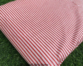 May include: Red and white striped fabric with a red fabric store logo.