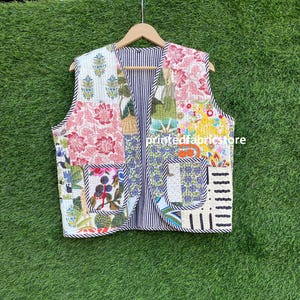 May include: A patchwork quilted vest with a variety of floral and geometric patterns in shades of pink, green, blue, and yellow. The vest has a striped lining and a zipper closure.