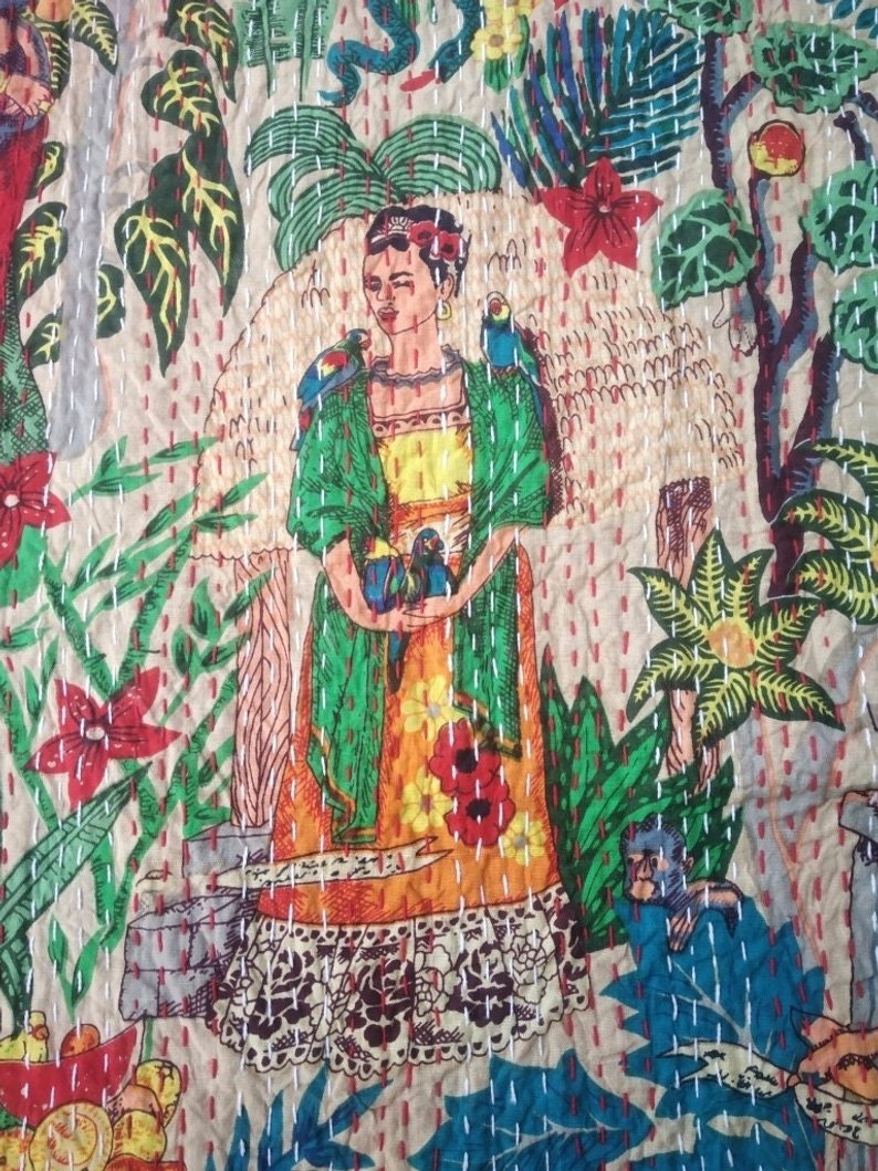 Puede incluir: Una colcha kantha colorida con un retrato de Frida Kahlo rodeada de plantas y p&aacute;jaros tropicales. La colcha est&aacute; hecha de algod&oacute;n y tiene un dise&ntilde;o cosido a mano.