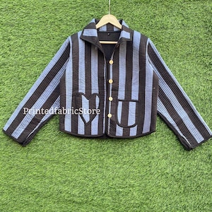 May include: A striped quilted jacket in black and pale blue, with a collar, button fastening, and two pockets featuring a heart design. The text "PrintedfabricStore" is visible on the front of the jacket.