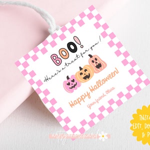 May include: A Halloween-themed gift tag with a pink and white checkered border. The tag features the word "BOO!" and three pumpkin illustrations. Text includes "Here's a treat for you!" and "Happy Halloween!"
