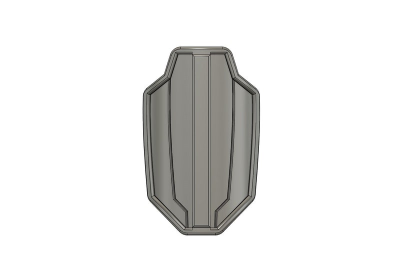 May include: A gray, geometrically shaped shield with a raised center section and a textured surface.