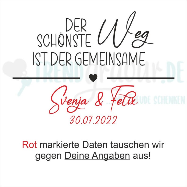 May include: A white card with black text that reads "Der sch&ouml;nste Weg ist der gemeinsame" with a black heart symbol. Below the text is the names "Svenja & Felix" in red cursive writing and the date "30.07.2022". The text "Rot markierte Daten tauschen wir gegen Deine Angaben aus!" is in red text.