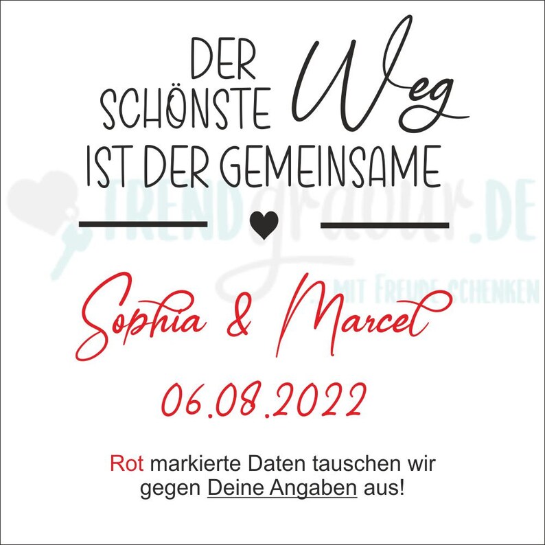 May include: A white card with black text that reads "Der sch&ouml;nste Weg ist der gemeinsame" with a black heart and a line underneath. Below the text is "Sophia & Marcel" in red cursive writing and the date "06.08.2022" in red. The text "Rot markierte Daten tauschen wir gegen Deine Angaben aus!" is in red at the bottom of the card.