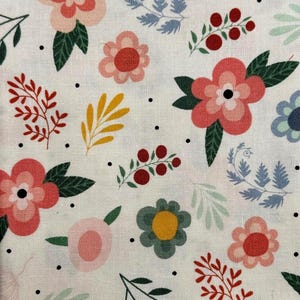 May include: White floral fabric with a repeating pattern of pink, red, and blue flowers, green leaves, and yellow accents. Small black dots are scattered across the design. The fabric is suitable for various craft projects.