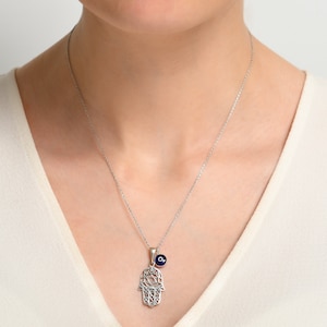 925 Sterling Silver Hamsa Necklace with a 7mm evil eye charm hanging on the side