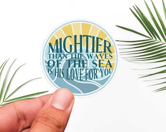 May include: A round sticker with a blue and yellow design. The sticker features a wave pattern and the text "MIGHTER THAN THE WAVES OF THE SEA IS HIS LOVE FOR YOU".