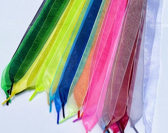 May include: A collection of colorful sheer ribbon laces in various shades of green, yellow, blue, pink, red, and white. The ribbons are arranged in a fan shape, with the ends of the ribbons fanned out.