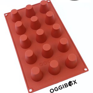 May include: A red silicone baking mould with 16 individual cone-shaped cavities. The mould is labelled "OGGIBOX" and says "2 Pack" on the top.