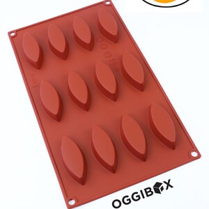 May include: A red silicone baking mold with 12 individual cavities shaped like elongated ovals. The mold is labeled "OGGIBOX" and "2 Pack".