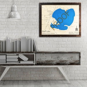 May include: A framed map of Shell Lake in Washburn County, Wisconsin. The map shows the lake's depth contours in blue, with the deepest point marked at 36 feet. The lake area is 2.515 acres.
