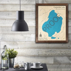 May include: A framed map of Carpenter Lake in Vilas County, Wisconsin. The map shows the lake's outline and depth contours in blue. The text "Lake Area - 537 acres" and "Deepest Point - 16 feet" is printed below the map.