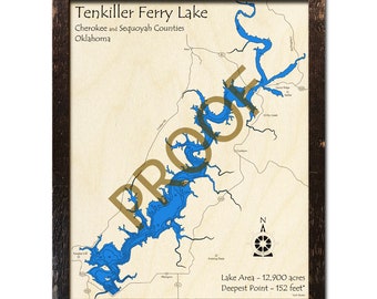 May include: A wooden map of Tenkiller Ferry Lake in Oklahoma, showing the lake's shape and depth contours. The map is framed in a dark brown wood frame. The text "Tenkiller Ferry Lake", "Cherokee and Sequoyah Counties", "Oklahoma", "Lake Area - 12,900 acres", and "Deepest Point - 152 feet*" is printed on the map.