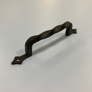 May include: Black twisted metal cabinet pull with a diamond-shaped end cap.