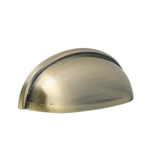 May include: A bronze-coloured cup pull cabinet handle with a curved design. The handle has a brushed metal finish and is set against a white background. Suitable for drawers and cabinets.