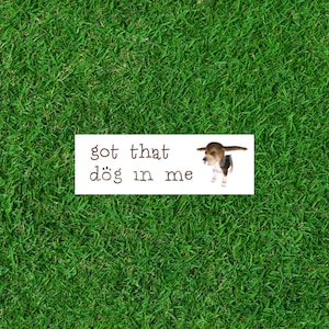 May include: A white sticker with the text "got that dog in me" and a small brown and white dog illustration.