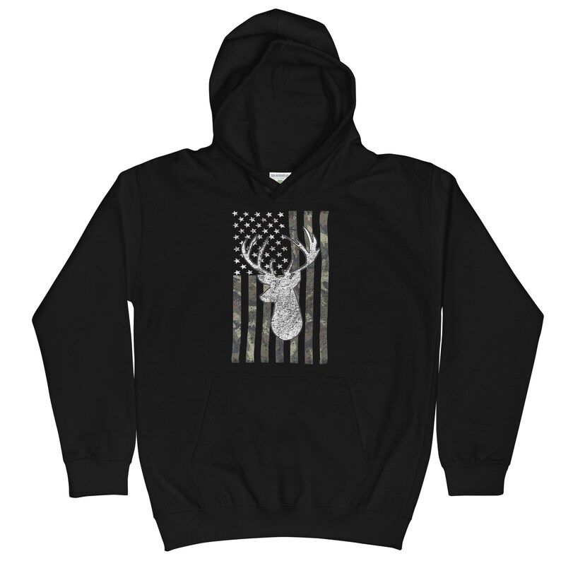 May include: Black hooded sweatshirt with a white deer silhouette on a camouflage American flag design.