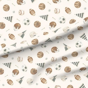 May include: A fabric pattern featuring a repeating watercolour illustration of sports equipment on a cream background. The design includes brown basketballs, brown footballs, white baseballs, white footballs, brown helmets, and striped pennants.