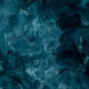 May include: A close-up of a teal-colored, plush fabric with a textured, fur-like appearance. The fabric has a soft, velvety look with varying shades of teal and dark blue, creating a sense of depth and dimension. The material appears to be luxurious and cozy.