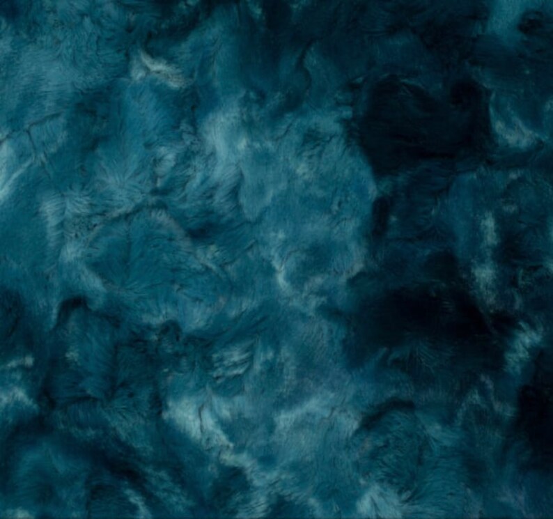 May include: A close-up of a teal-colored, plush fabric with a textured, fur-like appearance. The fabric has a soft, velvety look with varying shades of teal and dark blue, creating a sense of depth and dimension. The material appears to be luxurious and cozy.