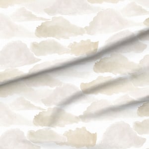 May include: A white fabric with a beige watercolour cloud pattern. The fabric is folded in the centre.