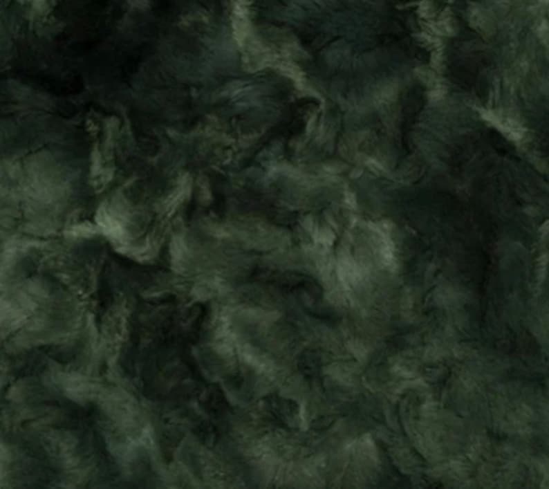 May include: Dark green faux fur fabric with a soft, textured appearance. The fabric has a swirling pattern, with variations in the green tones creating depth and dimension. The material appears plush and luxurious.