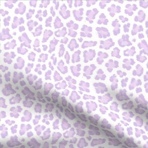 May include: A white fabric with a light purple leopard print pattern.
