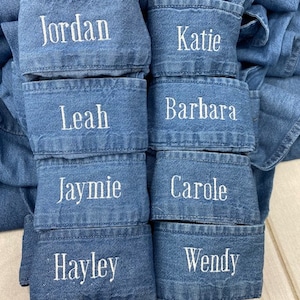 May include: Six pairs of denim jean cuffs with embroidered names: Jordan, Katie, Leah, Barbara, Jaymie, Carole, Hayley, and Wendy.
