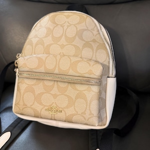 coach backpack white and brown 5671 Signature Women's Backpack, Im/Khaki/Chalk, Free Size Clothing, Shoes & Accessories Signature coated canvas Inside zip cell phone and multifunction pockets Laptop compartment with zip closure Zip closure recycled polyester lining Top handle with 2 drop Outside zip pockets Adjustable shoulder straps Fits a 12 (zip compartment) or 13 (main compartment) laptop 10 3/4 (L) x 14 (H) x 5 1/4 (W) Style No. Coach Signature Coated Canvas Backpack