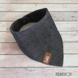 May include: A gray and black bandana with a brown leather patch that says "Luis".