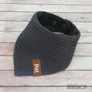 May include: Gray waffle-textured bandana with a brown leather label that says "piet" and two black snap buttons.