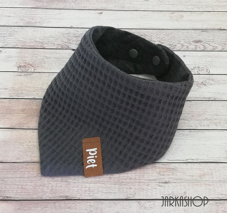 May include: Gray waffle-textured bandana with a brown leather label that says "piet" and two black snap buttons.