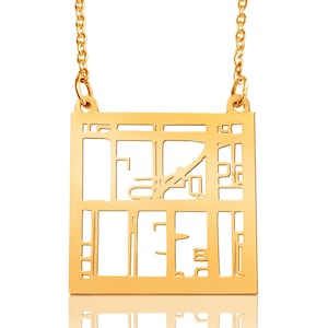 May include: A gold necklace with a square pendant featuring a detailed cutout design. The pendant is reminiscent of a city map or architectural plan.