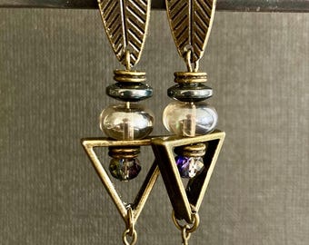 Brass and sparkling glass are combined to create a tribal geometric vibe. These post earrings are accented with a hematite disk.