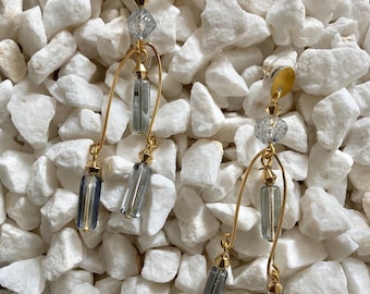 Stunning dangle & drop statement earrings. Pale ice blue glass + gold tone metal are a perfect match in thes minimalist style post earrings.