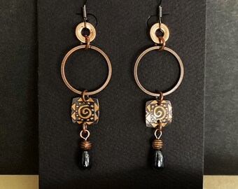 Gorgeous boho chic with geometric styling. Reimagined hoop earrings in antiquced copper. Lightweight. Dandgle & drop with black glass charm.