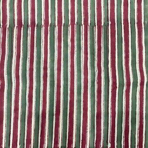 May include: A fabric with alternating vertical stripes of red, green, and white.