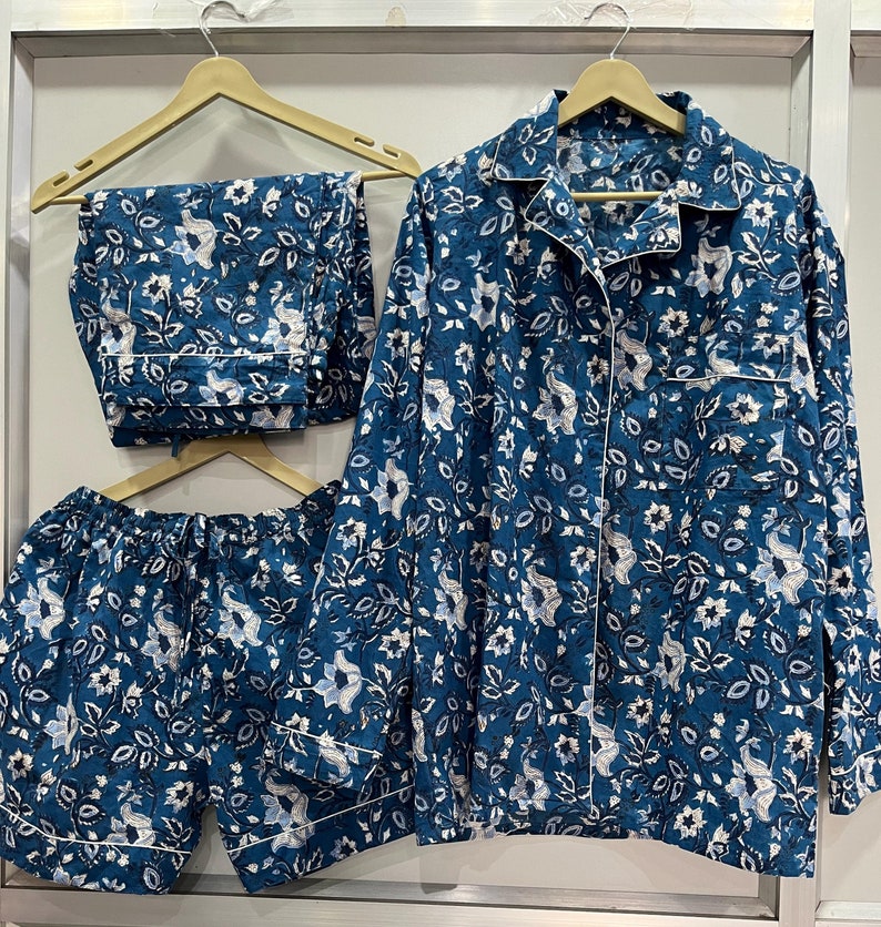May include: A blue pajama set with a floral print. The set includes a long-sleeved shirt and matching pants.