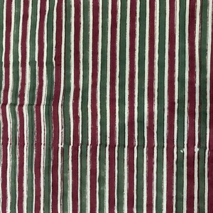 May include: A fabric with alternating stripes of burgundy, green, and white. The stripes are painted on the fabric, giving it a textured look.