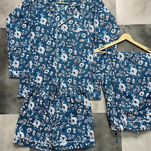 May include: A blue and white floral pajama set with a long-sleeved shirt and shorts.