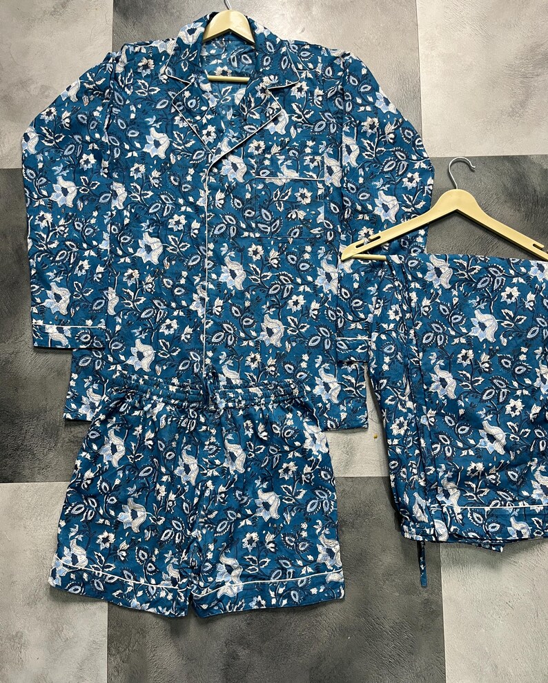 May include: A blue and white floral pajama set with a long-sleeved shirt and shorts.