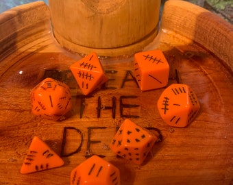 Orange Dice with Black and Red markings Includes dice bag. 7 piece polyhedral dice set Knucklebones of Bawwwk