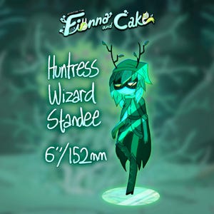 May include: A green Huntress Wizard standee from Adventure Time: Fionna and Cake. The character is 6 inches (152 mm) tall and has a mask, leafy hair, and antlers. The standee is on a glowing platform, with text that reads "Huntress Wizard Standee".