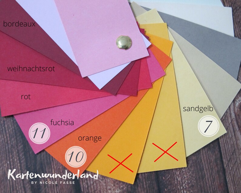 May include: A color chart with 11 different shades of red, orange, and yellow. The colors are labeled with German words, including "Bordeaux", "Weihnachtsrot", "Rot", "Fuchsia", "Orange", and "Sandgelb". The numbers 7, 10, and 11 are circled on the chart.