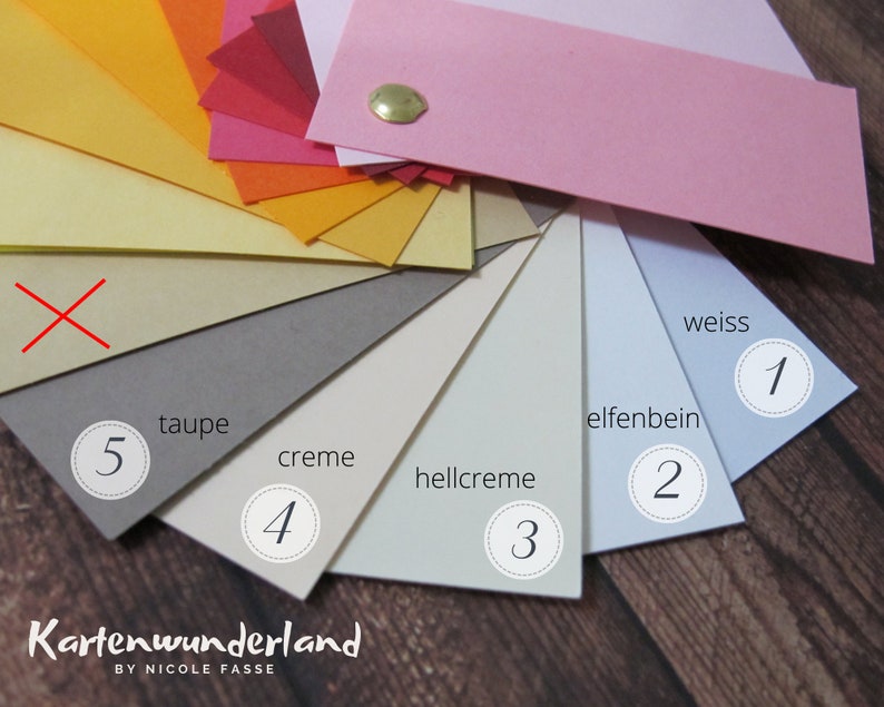 May include: A color chart of 10 different shades of paper, ranging from bright orange to light blue. The paper is arranged in a fan shape, with the darkest shade at the top and the lightest shade at the bottom. The shades are labeled with numbers 1 through 5 and the names "weiss", "elfenbein", "hellcreme", "creme", and "taupe".