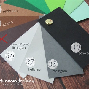 May include: A color chart with 10 different paper samples, numbered 33 through 39. The colors include green, brown, gray, black, and white. The text on the chart reads "rehbraun", "schoko", "lichtgrau", "hellgrau", "steingrau", and "schwarz".