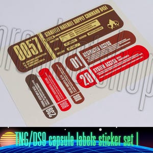 May include: A set of Star Trek: The Next Generation and Deep Space Nine capsule label stickers. The stickers are printed on white paper with red, brown, and gold text. The text on the stickers includes "Starfleet Materiel Supply Command 0451", "Restricted Access", "System Access", and "0057".